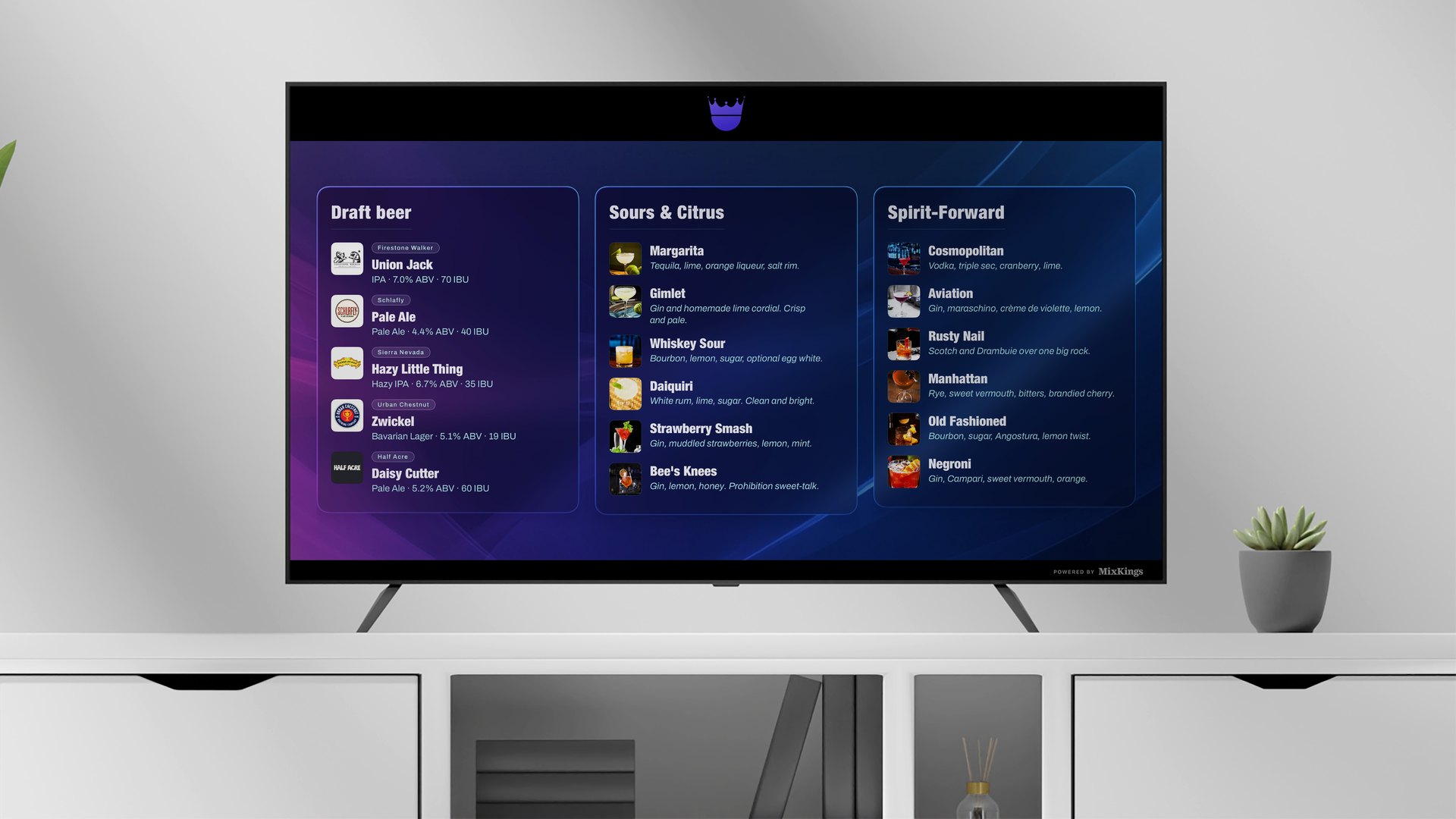 A TV on a white console showing a MixKings menu in three columns, Draft beer, Sours and Citrus, and Spirit-Forward, each drink with a small photo, a name, and a one-line description